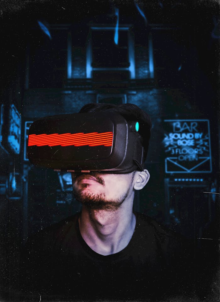 Home Young man immersed in a virtual reality experience using a VR headset, showcasing futuristic tech in a gaming environment.